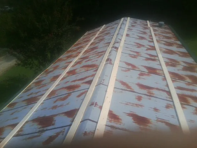 Rusted metal roof panels with new wood purlins before replacement — Storm Damage Roof Repair in Valparaiso by Roofing Brothers