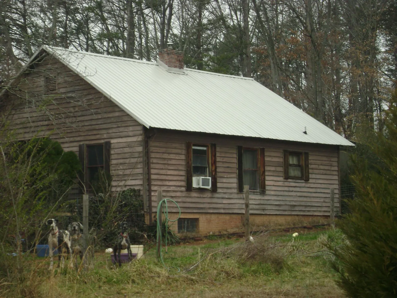 White metal roof on an old wood sided farmhouse, from a Metal Roof Installation job in Valparaiso